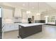 Bright modern kitchen with white cabinets, an island with breakfast bar, and stainless steel appliances at 250 Ellington Rd, Graham, NC 27253