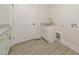 A practical laundry room featuring sleek cabinets, modern fixtures, and a convenient utility sink at 250 Ellington Rd, Graham, NC 27253