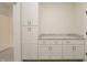 Bright laundry room with white cabinetry, granite countertops, and convenient access to other areas at 250 Ellington Rd, Graham, NC 27253