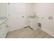 A practical laundry room featuring sleek cabinets, modern fixtures, and a convenient utility sink at 250 Ellington Rd, Graham, NC 27253
