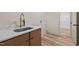 Laundry room featuring stainless steel sink and hardwood floors at 250 Ellington Rd, Graham, NC 27253