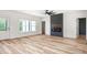Bright living room featuring luxury vinyl plank flooring, a ceiling fan, and a cozy fireplace at 250 Ellington Rd, Graham, NC 27253