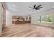 Open floor plan living room with light wood flooring and modern lighting at 250 Ellington Rd, Graham, NC 27253