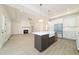 Expansive view of the kitchen and living room with a fireplace, plenty of natural light, and an open floor plan at 250 Ellington Rd, Graham, NC 27253