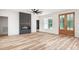 Elegant living room with black fireplace, hardwood floors, and a natural wood and glass exterior door at 250 Ellington Rd, Graham, NC 27253