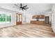 Spacious open-concept living area with hardwood floors, a kitchen, and a large window at 250 Ellington Rd, Graham, NC 27253