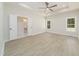 Large main bedroom with wood-look floors, recessed lighting, and a view into ensuite at 250 Ellington Rd, Graham, NC 27253
