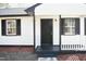 Black front door with white columns and a small porch at 2500 Sundial Cir, Durham, NC 27704