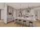 Bright kitchen features a central island with seating, stainless appliances and modern pendant lighting at 2801 Mount View Church Rd, Moncure, NC 27559