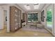 Bright sitting room with large windows, hardwood floors, comfortable sofa and glass display cabinets at 2801 Mount View Church Rd, Moncure, NC 27559