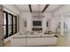 Bright living room with large windows, modern lighting, fireplace, and comfortable sofa at 2801 Mount View Church Rd, Moncure, NC 27559