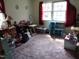 Cozy bedroom featuring carpeted floors, two windows, and playful decor at 306 Eastway Ln, Graham, NC 27253