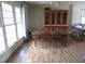 Spacious dining room with large windows, hardwood floors, and a large wooden dining table at 306 Eastway Ln, Graham, NC 27253