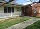 Charming home featuring a cozy front porch and a combination of siding and brick exterior at 306 Eastway Ln, Graham, NC 27253