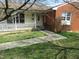 Charming home featuring a cozy front porch and a combination of siding and brick exterior at 306 Eastway Ln, Graham, NC 27253