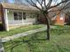 Quaint home with a welcoming front porch and mature trees at 306 Eastway Ln, Graham, NC 27253