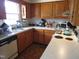 Cozy kitchen with light wood cabinets and appliances at 306 Eastway Ln, Graham, NC 27253