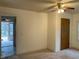 Simple bedroom with ceiling fan and access to a back porch at 3077 Christian Light Road Rd, Fuquay Varina, NC 27526