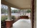 Spacious front porch with wooden swing and brick columns at 3077 Christian Light Road Rd, Fuquay Varina, NC 27526