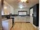Bright kitchen with white cabinets, stainless steel appliances, and light wood floors at 3077 Christian Light Road Rd, Fuquay Varina, NC 27526