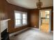 Living room with wood paneling and view into kitchen at 3077 Christian Light Road Rd, Fuquay Varina, NC 27526