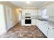 Modern kitchen with white cabinets and tiled floor at 314 Lawrence Street St, Roxboro, NC 27573