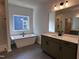 Bathroom with modern tub, sleek shower, double sink vanity, and ample natural light at 3271 Roundly Rd # 9, New Hill, NC 27562
