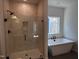 Bathroom features glass shower, modern tub, and sleek black fixtures at 3271 Roundly Rd # 9, New Hill, NC 27562