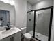 Bathroom features a modern glass shower with gray tiling and black hardware at 3271 Roundly Rd # 9, New Hill, NC 27562
