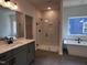 Bathroom featuring modern tub, sleek shower, and double sink vanity at 3271 Roundly Rd # 9, New Hill, NC 27562