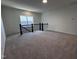Spacious bonus room with neutral carpeting and a black railing overlooking the downstairs at 3271 Roundly Rd # 9, New Hill, NC 27562