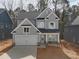 Two-story house with gray siding, white garage door, and stone accents at 3271 Roundly Rd # 9, New Hill, NC 27562