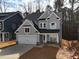 Two-story house with gray siding, white garage door, and stone accents at 3271 Roundly Rd # 9, New Hill, NC 27562