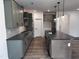 Gourmet kitchen with stylish gray cabinets, island, and stainless steel appliances at 3271 Roundly Rd # 9, New Hill, NC 27562