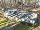 White two-story house nestled among tall trees at 3872 Hope Valley Rd, Durham, NC 27707