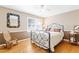 Bedroom with hardwood floors, metal bed frame, and rocking chair at 3872 Hope Valley Rd, Durham, NC 27707