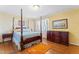 Bedroom with wood post bed, dresser, and hardwood floors at 3872 Hope Valley Rd, Durham, NC 27707