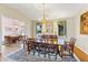 Elegant dining room boasts a large table, hardwood floors, and views to another dining area at 3872 Hope Valley Rd, Durham, NC 27707