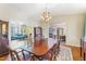 Formal dining room with large table, chandelier, and views to living room at 3872 Hope Valley Rd, Durham, NC 27707