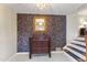 Entryway with tiled floors, antique dresser, and floral wallpaper at 3872 Hope Valley Rd, Durham, NC 27707