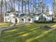 White two-story house with a large front yard and driveway at 3872 Hope Valley Rd, Durham, NC 27707