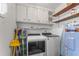 Laundry room with washer, dryer, and ample storage cabinets at 3872 Hope Valley Rd, Durham, NC 27707