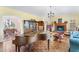 Spacious living room with hardwood floors, piano, and views into dining room at 3872 Hope Valley Rd, Durham, NC 27707