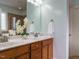 Double vanity bathroom with wood cabinets and a view of the shower at 401 Streamwood Dr, Holly Springs, NC 27540