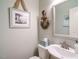 Small bathroom with sink, toilet, and decorative anchor at 401 Streamwood Dr, Holly Springs, NC 27540