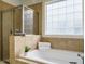 Bathroom with soaking tub, shower, and tile flooring at 401 Streamwood Dr, Holly Springs, NC 27540