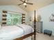 Serene bedroom with a four-poster bed and large window at 401 Streamwood Dr, Holly Springs, NC 27540