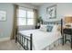 Bedroom with a metal bed frame and window coverings at 401 Streamwood Dr, Holly Springs, NC 27540