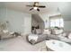 Spacious bonus room with sectional sofa and ceiling fan at 401 Streamwood Dr, Holly Springs, NC 27540