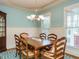 Formal dining room with light blue walls, hardwood floors and a wooden table at 401 Streamwood Dr, Holly Springs, NC 27540
